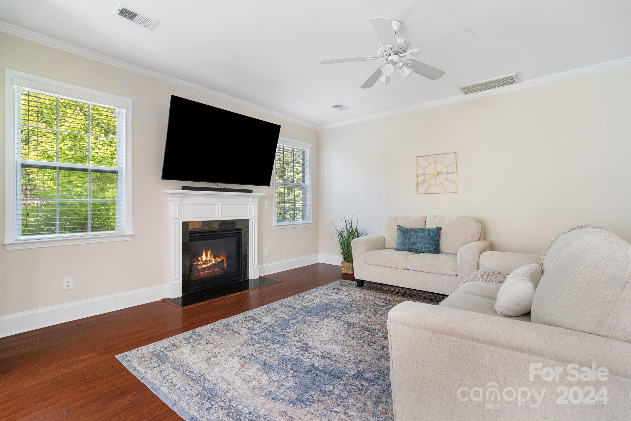 580 Rosemary Lane Fort Mill, SC 29708 - Photo 10 of 37 a living room with furniture a flat screen tv and a fireplace