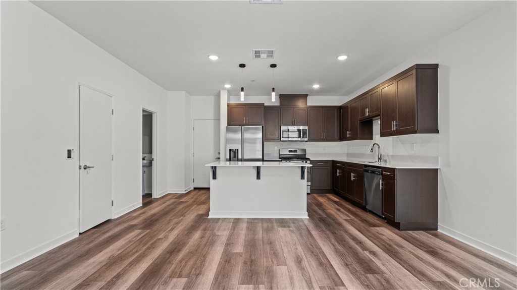 35172 Grove Trail Fallbrook, CA 92028 - Photo 2 of 30 a large white kitchen with stainless steel appliances granite countertop a stove and a sink