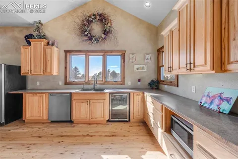 a kitchen with stainless steel appliances granite countertop a stove a sink and a granite counter tops