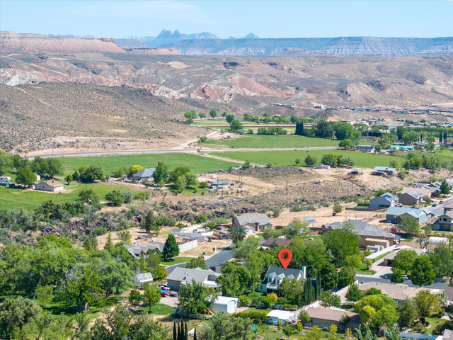 246 West Mount Charm Road Toquerville, UT 84774 - Photo 63 of 70 Aerial view of property's location with a mountainous background and nearby suburban area