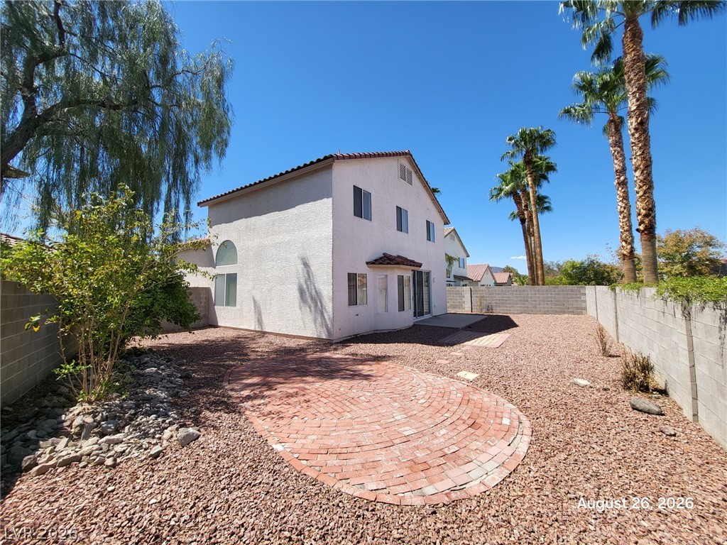 994 Broken Reed Court Henderson, NV 89015 - Photo 18 of 18 A spacious gravel backyard features a custom brick patio under clear desert skies.