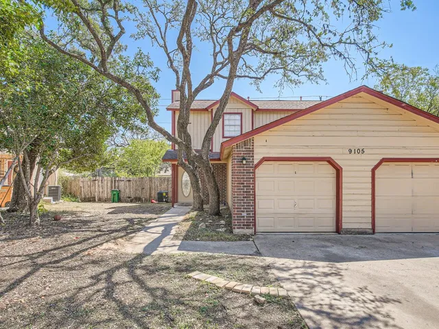 a backyard of a house with large trees and covered with snow