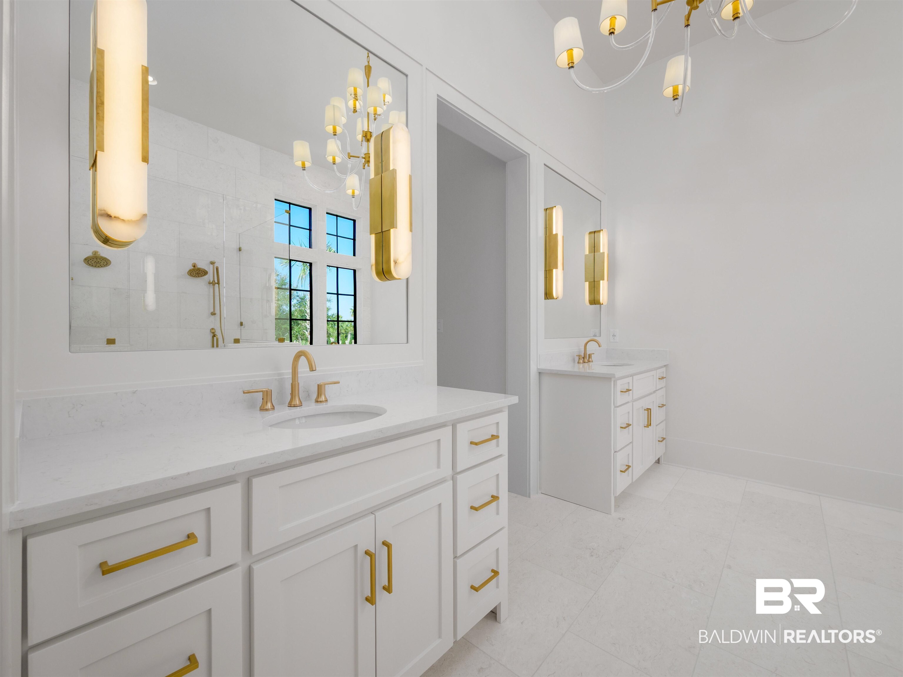 31292 River Road Orange Beach, AL 36561 - Photo 21 of 48 Full bathroom featuring a chandelier, two vanities, a sink, and walk in shower