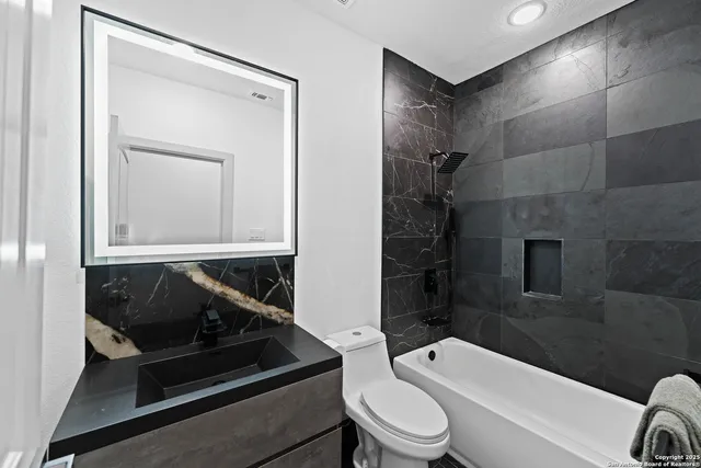a bathroom with a toilet a sink and bathtub