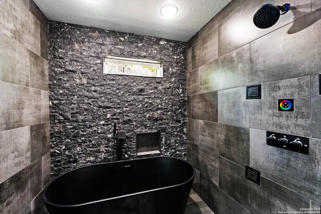 a bathroom with a shower and a sink