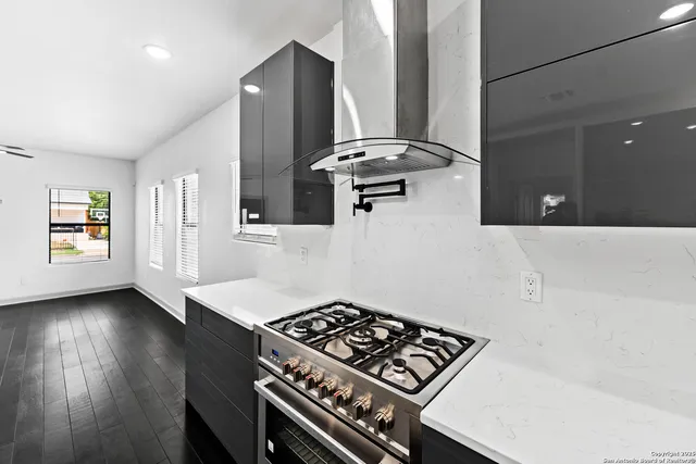a kitchen with stainless steel appliances granite countertop a stove and a refrigerator