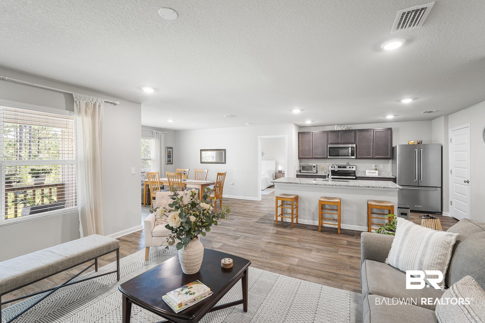 10232 Brodick Loop Spanish Fort, AL 36527 - Photo 6 of 29 Living area with light wood finished floors, recessed lighting, baseboards, and a textured ceiling