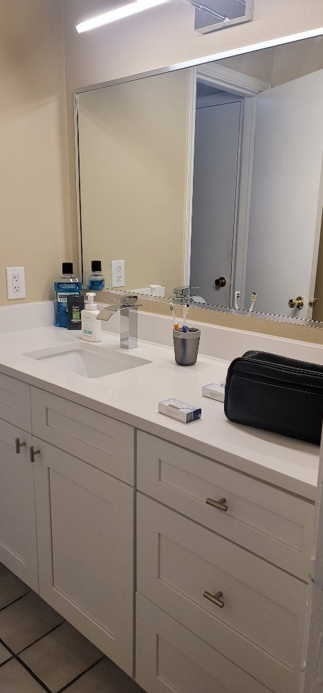 2802 Nueces Street, Unit 101 Austin, TX 78705 - Photo 11 of 20 a bathroom with double sink and a mirror