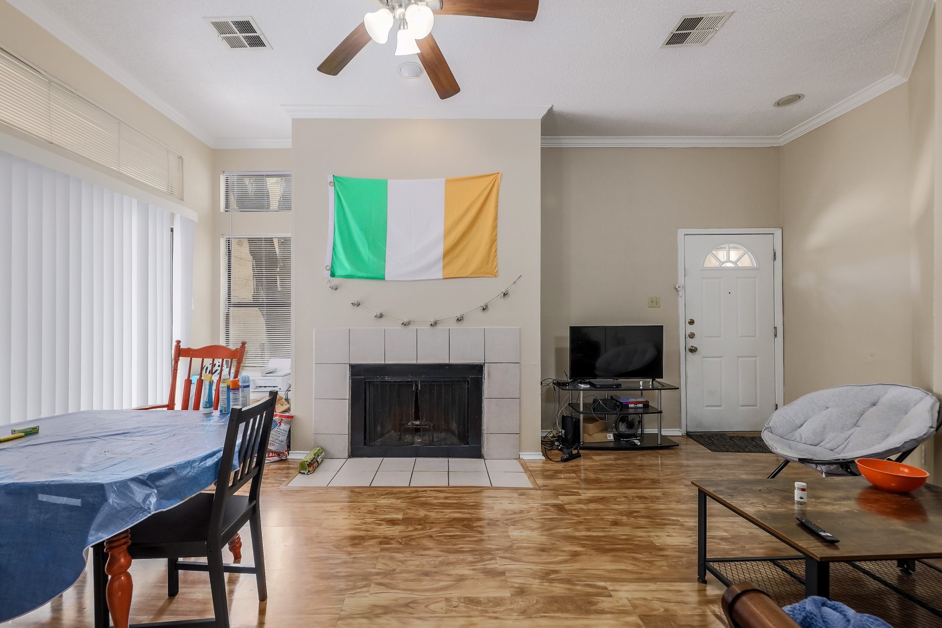 2802 Nueces Street, Unit 101 Austin, TX 78705 - Photo 5 of 20 a living room with furniture a fireplace and a flat screen tv