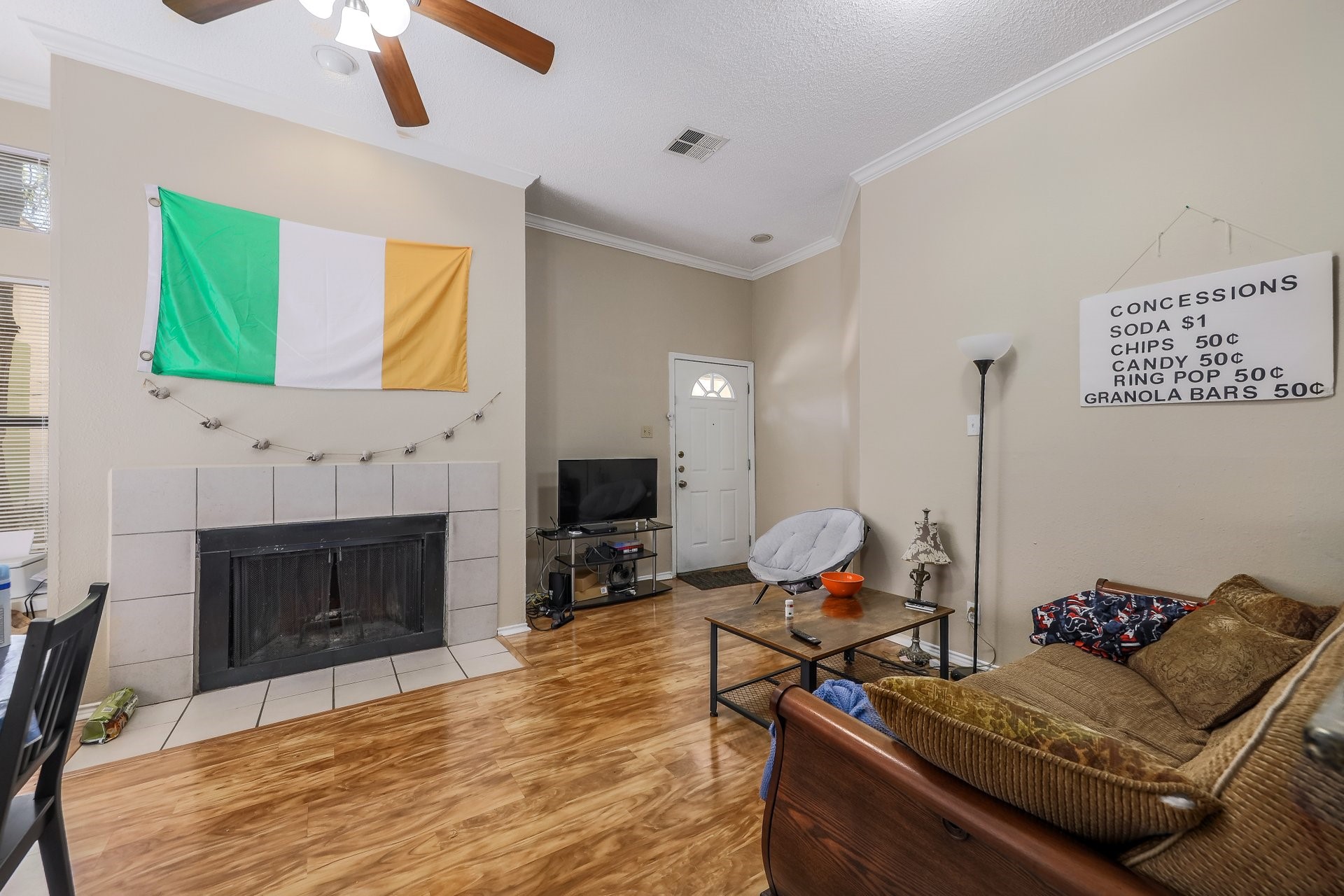 2802 Nueces Street, Unit 101 Austin, TX 78705 - Photo 6 of 20 a living room with furniture a fireplace and a flat screen tv