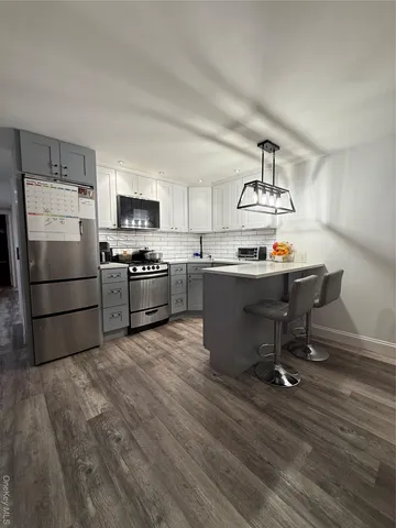 a kitchen with granite countertop a sink appliances and cabinets