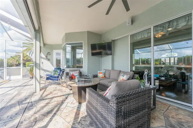 a view of a dining room with furniture large windows and wooden floor
