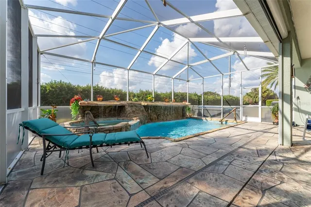 a view of a house with backyard and sitting area