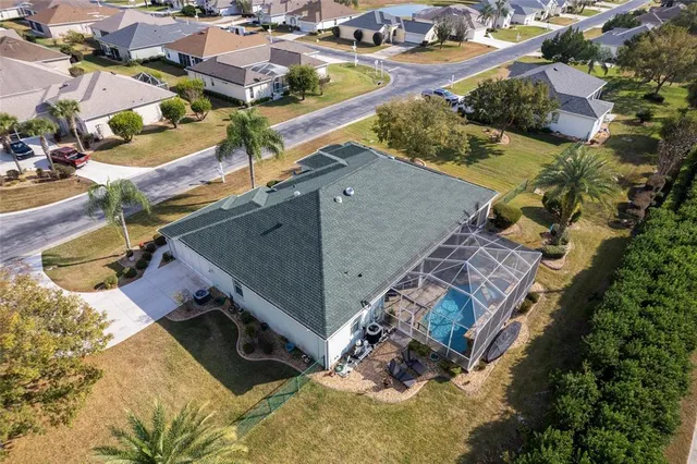 a living room with fireplace furniture and a large window