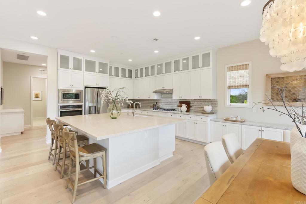1352 Baumgartner Way Escondido, CA 92026 - Photo 14 of 47 a kitchen with stainless steel appliances kitchen island granite countertop a sink and cabinets