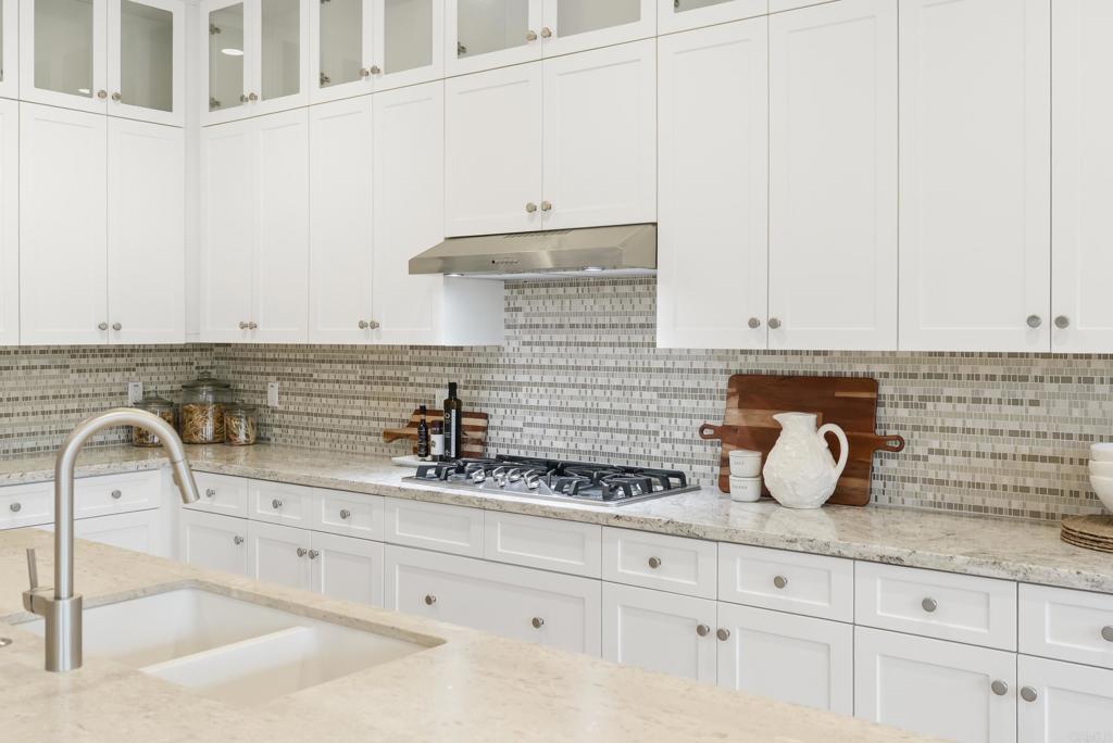 1352 Baumgartner Way Escondido, CA 92026 - Photo 15 of 47 a kitchen with granite countertop white cabinets and a sink