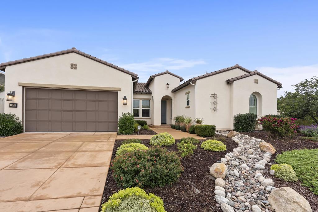 1352 Baumgartner Way Escondido, CA 92026 - Photo 2 of 47 a view of a white house with a yard