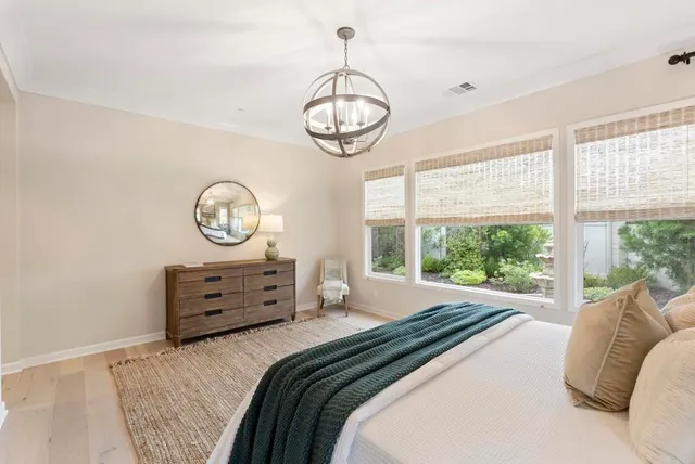 a bed room with a bed mirror and window