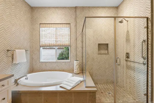 a bathroom with a white bath tub and a shower