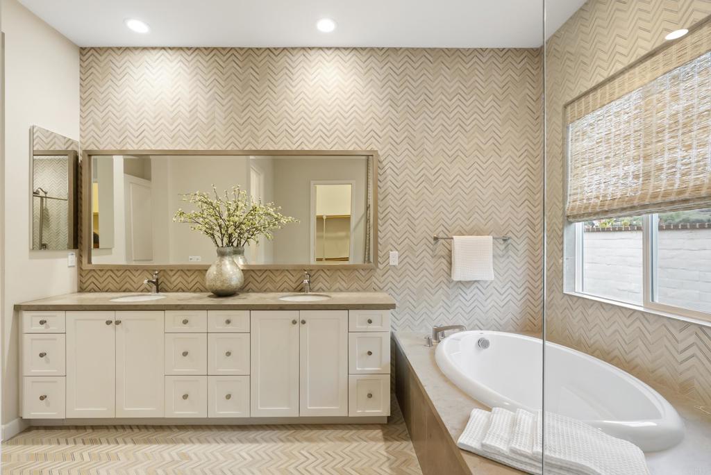1352 Baumgartner Way Escondido, CA 92026 - Photo 27 of 47 a bathroom with a granite countertop sink a large mirror and bathtub