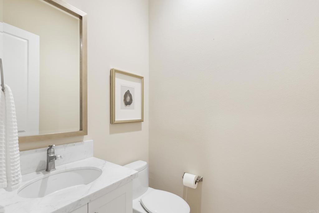 1352 Baumgartner Way Escondido, CA 92026 - Photo 30 of 47 a bathroom with a sink mirror and toilet
