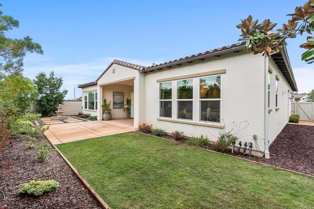 a view of a backyard with sitting area