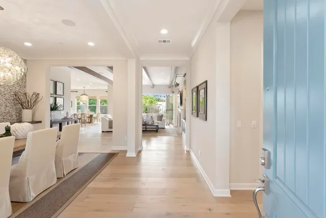 a hallway with white cabinets and wooden floor