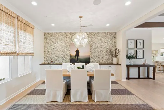 a living room with a large window and furniture
