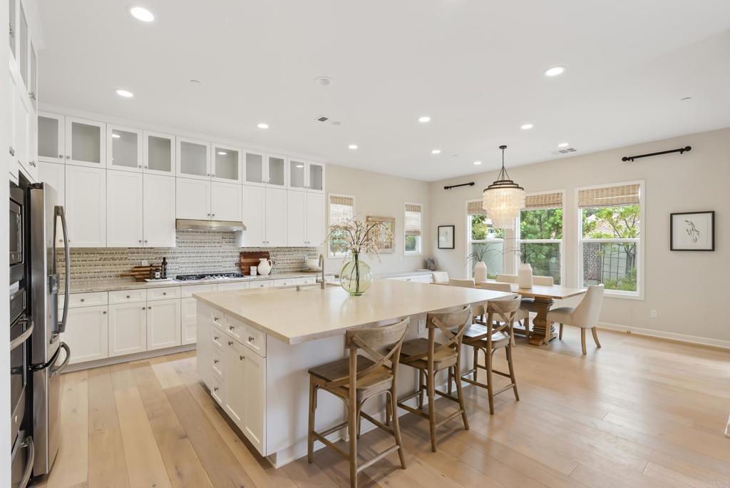 1352 Baumgartner Way Escondido, CA 92026 - Photo 10 of 47 a large kitchen with kitchen island a island a stove a table and chair in it