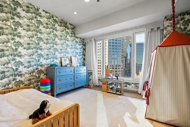 a bedroom with furniture and natural light