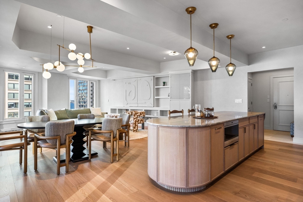 10 Rowes Wharf, Unit 1003 Boston, MA 02110 - Photo 8 of 25 a kitchen with stainless steel appliances granite countertop a sink and a refrigerator
