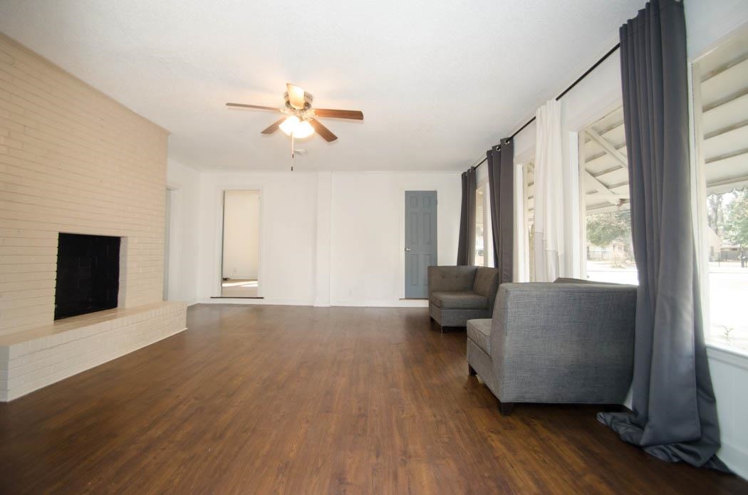 4572 Princeton Road Memphis, TN 38117 - Photo 4 of 24 Living room featuring a fireplace, dark wood-type flooring, and a ceiling fan