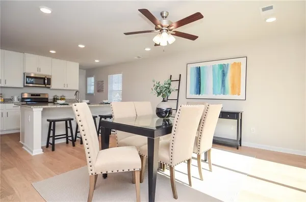 a view of a dining room with furniture and wooden floor