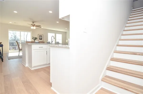 a kitchen with stainless steel appliances granite countertop a sink and a fireplace
