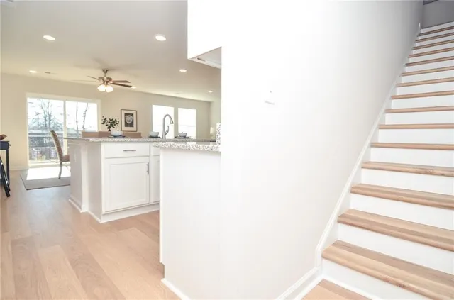 a kitchen with stainless steel appliances granite countertop a sink and a fireplace