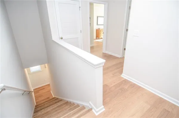 a view of hallway with wooden floor