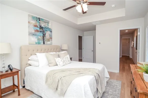 a bedroom with a large bed and a chandelier