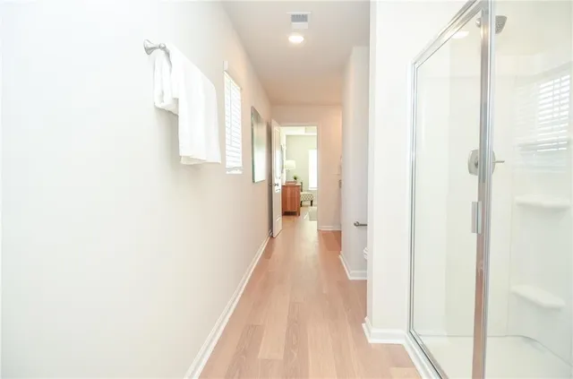 a view of a hallway with wooden floor