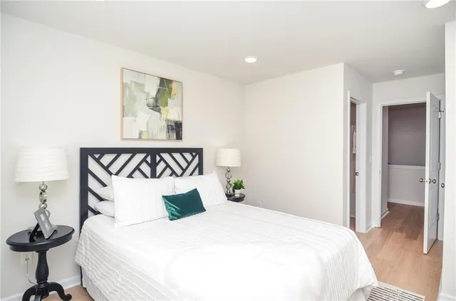 a bedroom with a bed and a painting on the wall