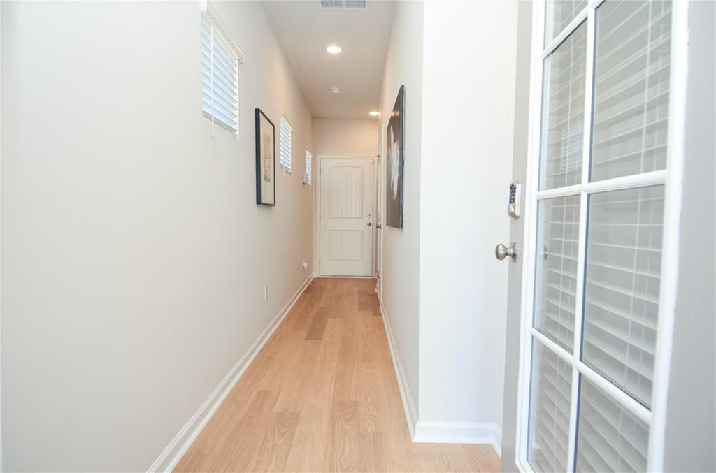 4553 High Rdg Court Sugar Hill, GA 30518 - Photo 3 of 39 a view of a hallway with wooden floor and entryway