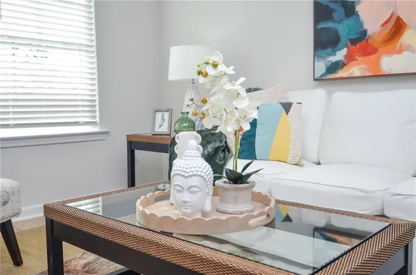 a dining table with a vase of flowers