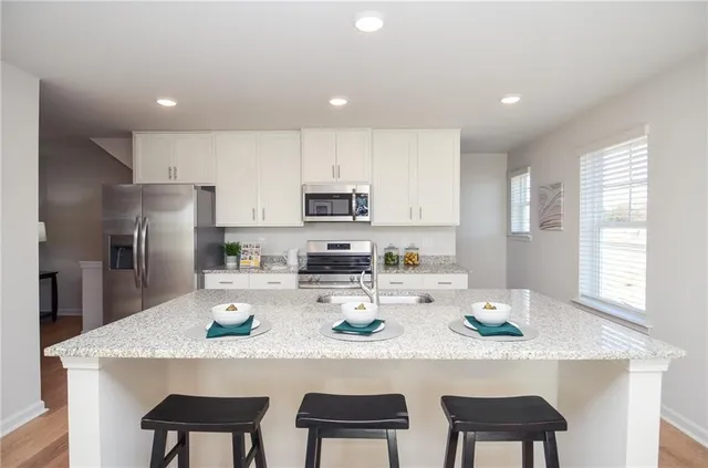 a kitchen with refrigerator and cabinets