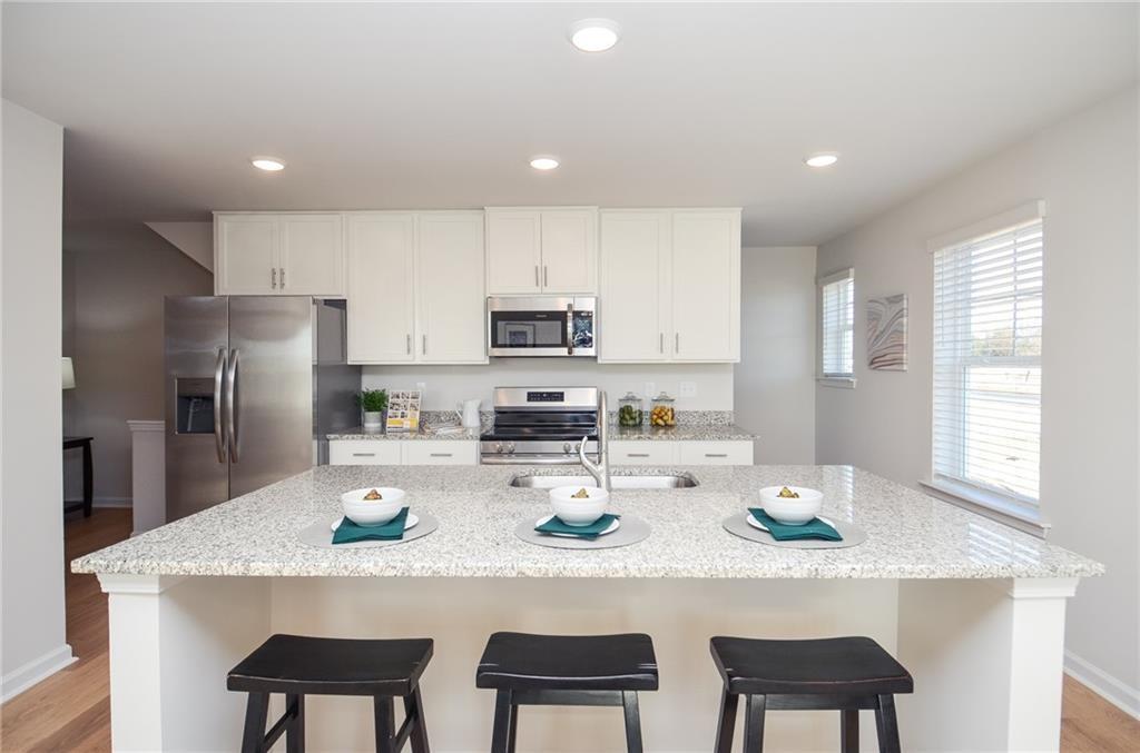 4553 High Rdg Court Sugar Hill, GA 30518 - Photo 8 of 39 a kitchen with refrigerator and cabinets