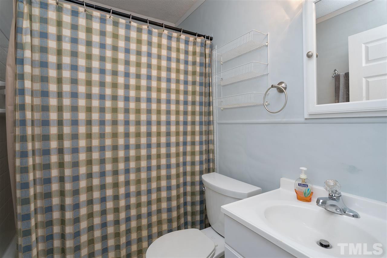 3315 Zacks Mill Road, Unit C Angier, NC 27501 - Photo 12 of 25 a bathroom with a sink toilet and shower