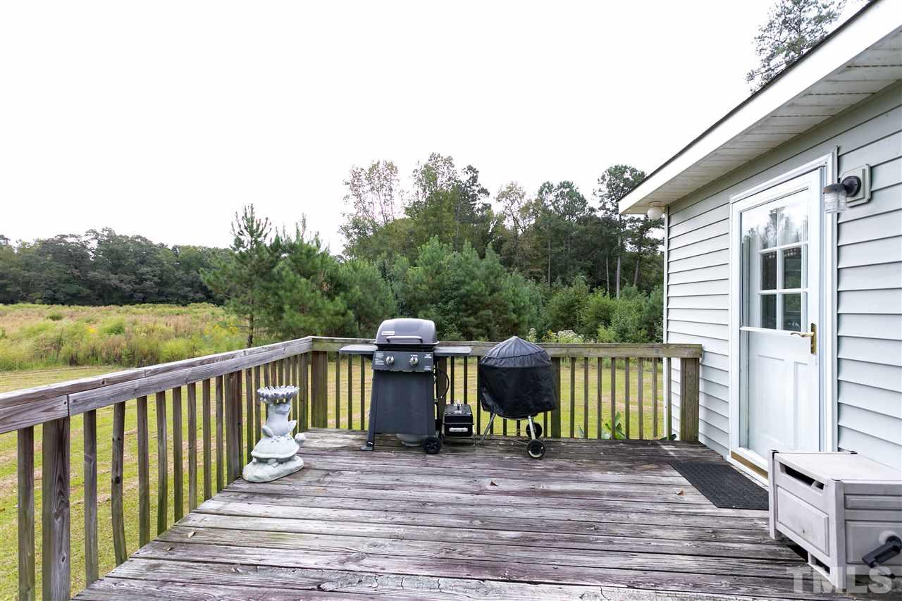 3315 Zacks Mill Road, Unit C Angier, NC 27501 - Photo 19 of 25 a view of a deck with wooden floor and fence next to a yard