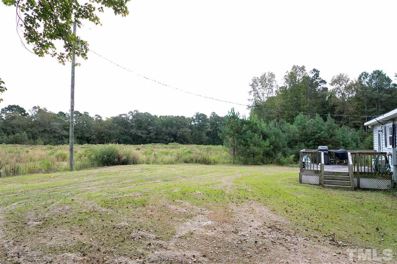 3315 Zacks Mill Road, Unit C Angier, NC 27501 - Photo 21 of 25 a view of a garden with a bench