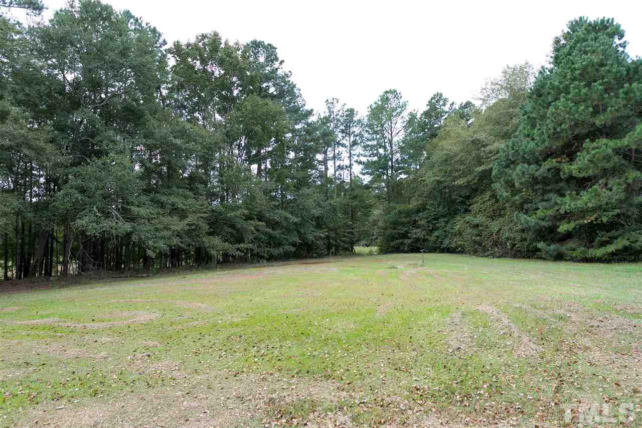 3315 Zacks Mill Road, Unit C Angier, NC 27501 - Photo 22 of 25 a view of a field with trees in the background
