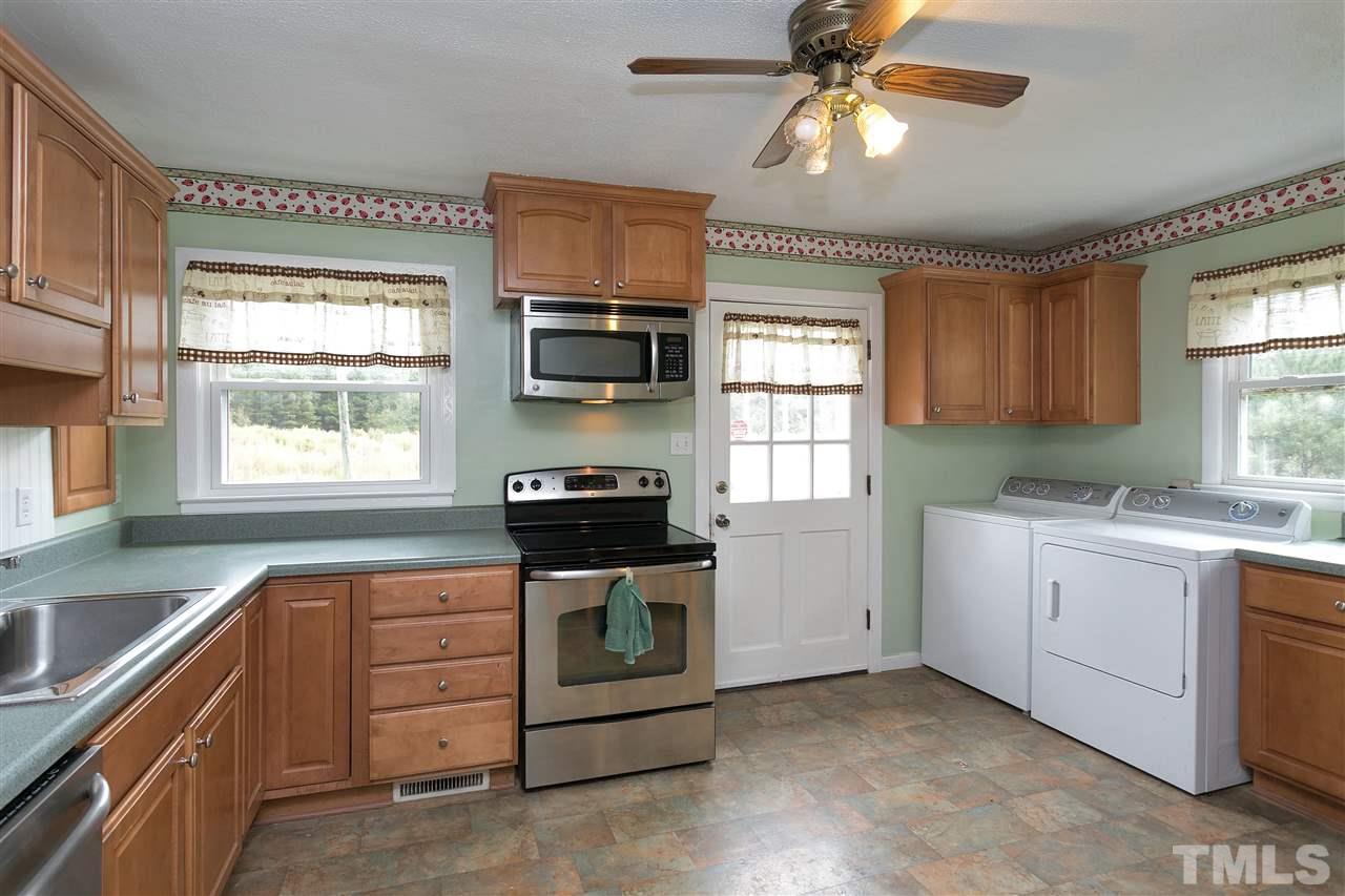 3315 Zacks Mill Road, Unit C Angier, NC 27501 - Photo 7 of 25 a kitchen with a stove microwave and cabinets