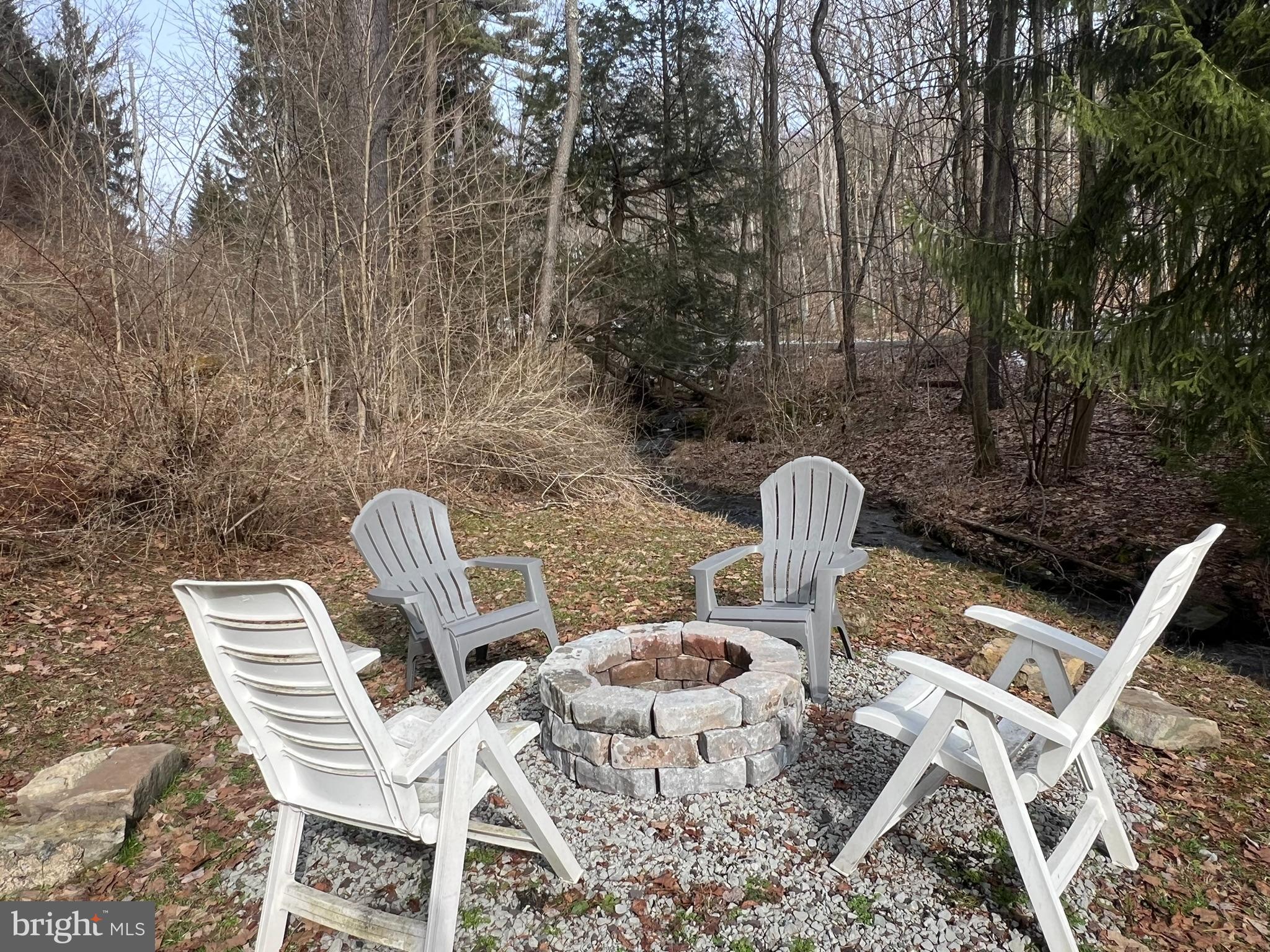 193 Gravelly Run Road McHenry, MD 21541 - Photo 19 of 57 a view of backyard with seating space and trees