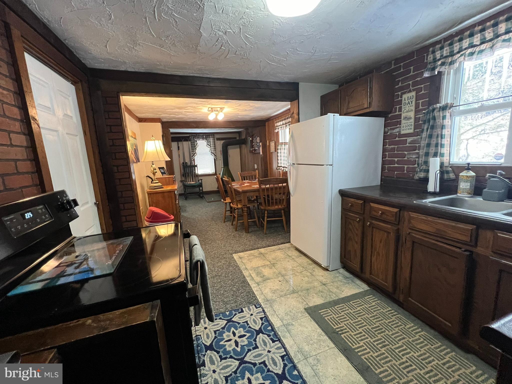 193 Gravelly Run Road McHenry, MD 21541 - Photo 23 of 57 a kitchen with sink a refrigerator and chairs